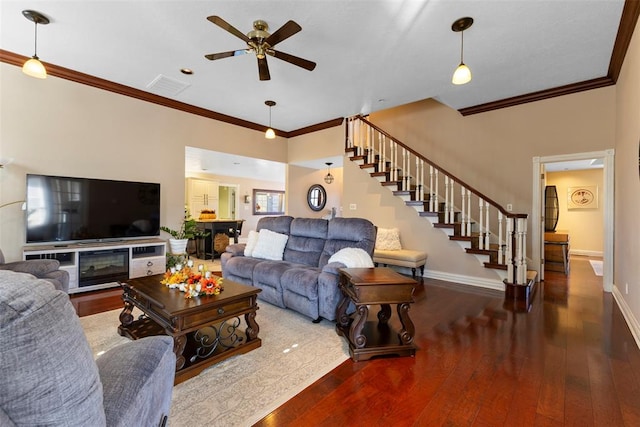 living room with ceiling fan, ornamental molding, and hardwood / wood-style flooring