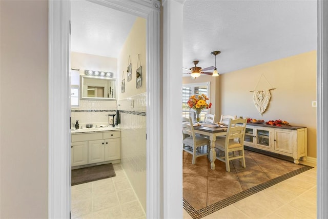 bathroom with backsplash, ceiling fan, tile patterned flooring, and vanity