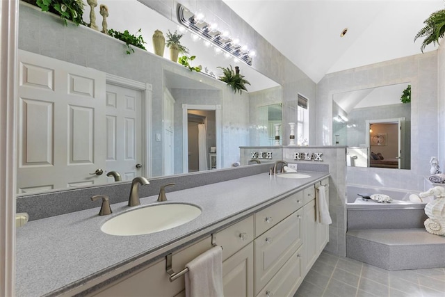 bathroom with vanity, tile walls, and lofted ceiling