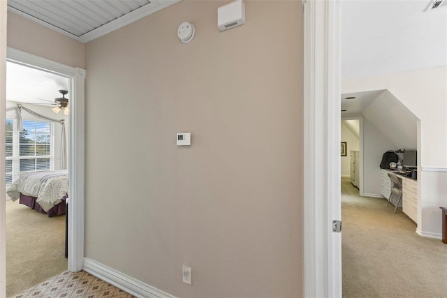 hallway with light colored carpet