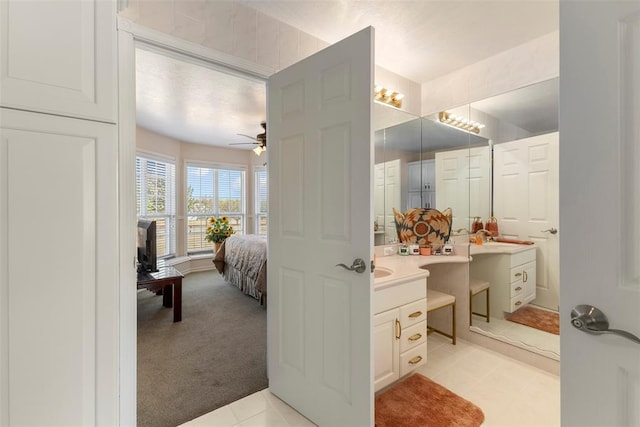 bathroom with tile patterned floors, ceiling fan, and vanity