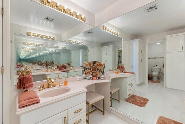 bathroom with tile patterned floors, vanity, and toilet