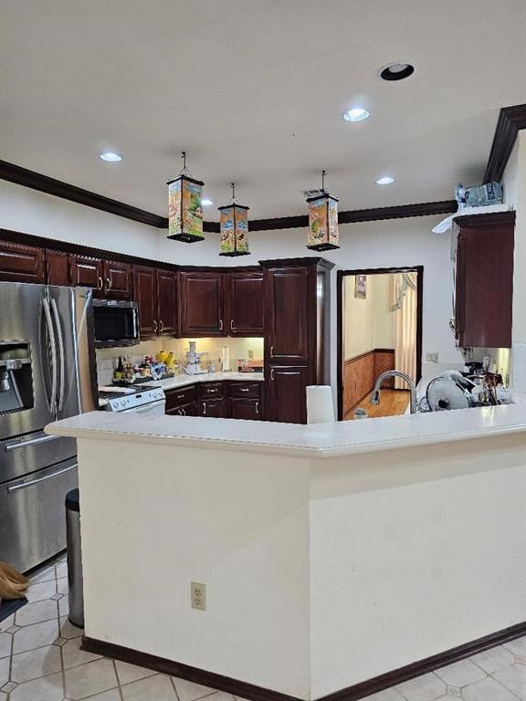 kitchen with kitchen peninsula, stainless steel appliances, and ornamental molding