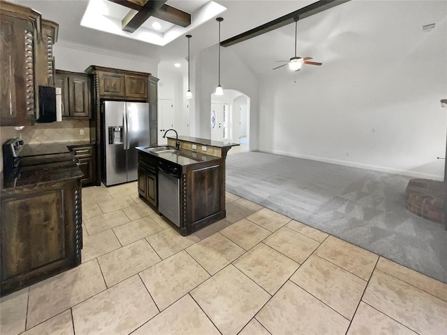 kitchen with ceiling fan, stainless steel refrigerator with ice dispenser, light carpet, dark brown cabinets, and a center island with sink