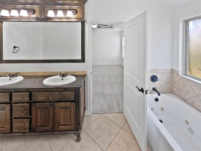 bathroom with tile patterned floors, ceiling fan, a bathtub, and vanity