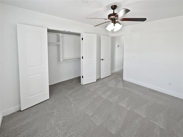 unfurnished bedroom featuring ceiling fan, light colored carpet, and a closet