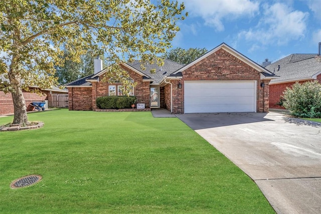 516 S Quail Run, Altus, OK 73521 - traditional home featuring a chimney, concrete driveway, an attached garage, a front yard, and brick siding