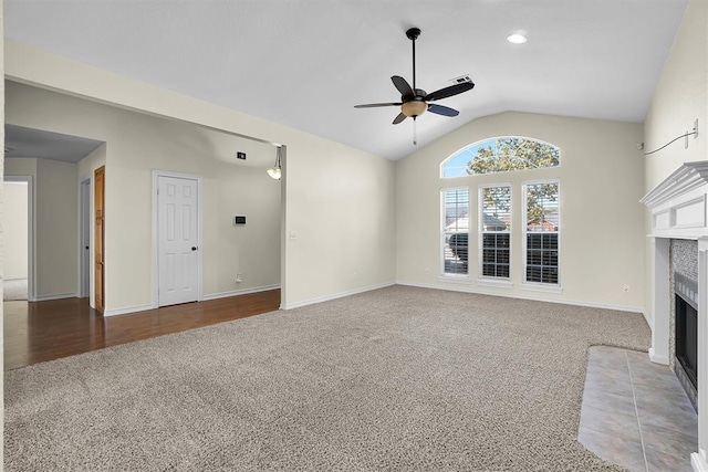 unfurnished living room with ceiling fan, carpet floors, and vaulted ceiling