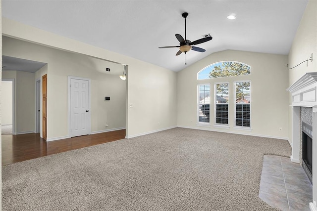 516 S Quail Run, Altus, OK 73521 - unfurnished living room with carpet flooring, ceiling fan, lofted ceiling, and a tiled fireplace