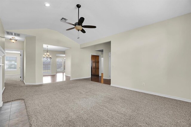 516 S Quail Run, Altus, OK 73521 - unfurnished living room with carpet, ceiling fan, vaulted ceiling, and a chandelier