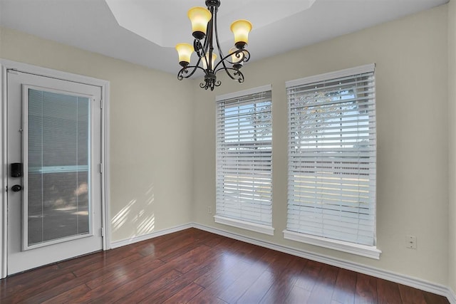 516 S Quail Run, Altus, OK 73521 - spare room with a chandelier and dark wood-style flooring