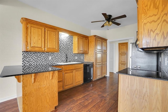 kitchen with dark wood-type flooring, a kitchen breakfast bar, sink, decorative backsplash, and black dishwasher