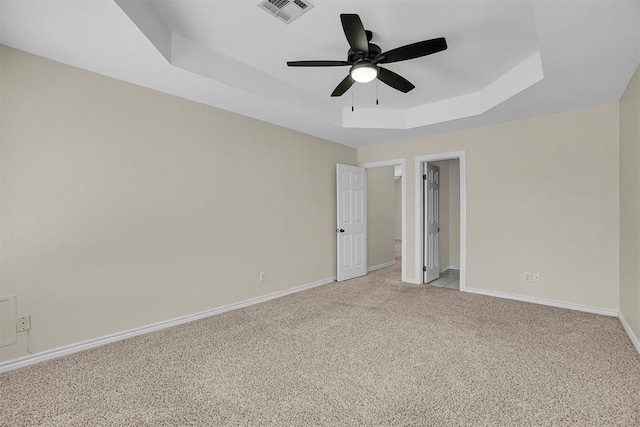 516 S Quail Run, Altus, OK 73521 - unfurnished bedroom with a raised ceiling, light carpet, a spacious closet, a ceiling fan, and a closet