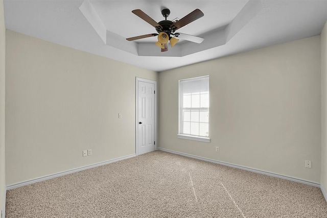 516 S Quail Run, Altus, OK 73521 - carpeted spare room with a tray ceiling and ceiling fan