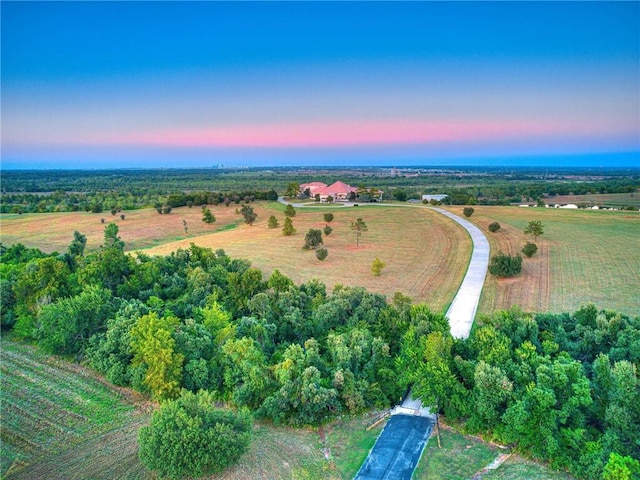 aerial view at dusk featuring a rural view