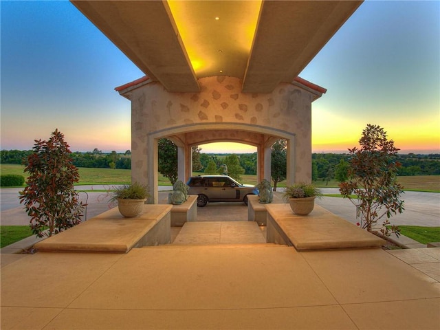 view of patio terrace at dusk