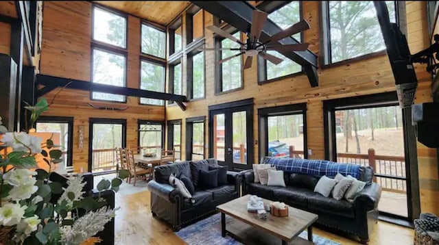 sunroom / solarium with french doors, ceiling fan, lofted ceiling, and wood ceiling