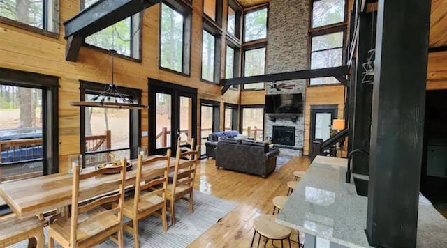 dining area featuring a high ceiling, plenty of natural light, and hardwood / wood-style floors