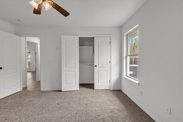 unfurnished bedroom with carpet, a closet, and ceiling fan