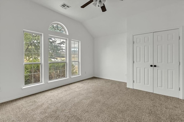 unfurnished bedroom featuring ceiling fan, carpet, and multiple windows