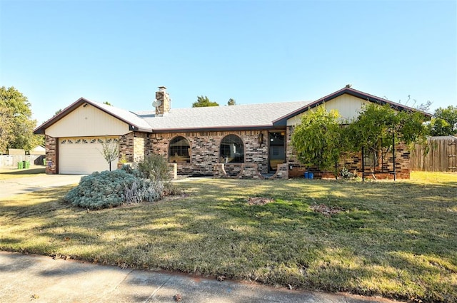 view of front of property featuring a front yard and a garage