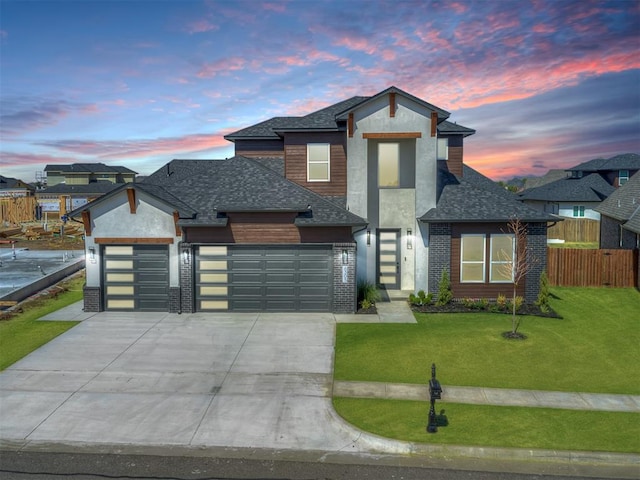 view of front of property featuring a yard and a garage