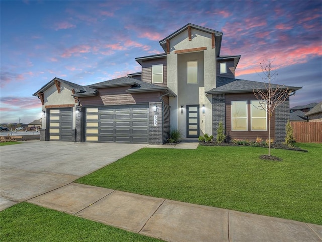 view of front of house featuring a yard and a garage