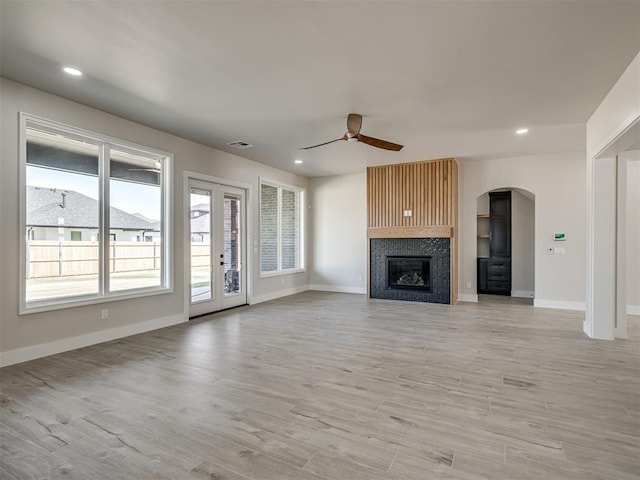 unfurnished living room featuring ceiling fan and light hardwood / wood-style floors