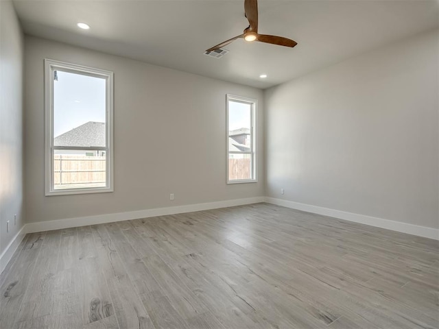 spare room featuring light wood-type flooring and ceiling fan