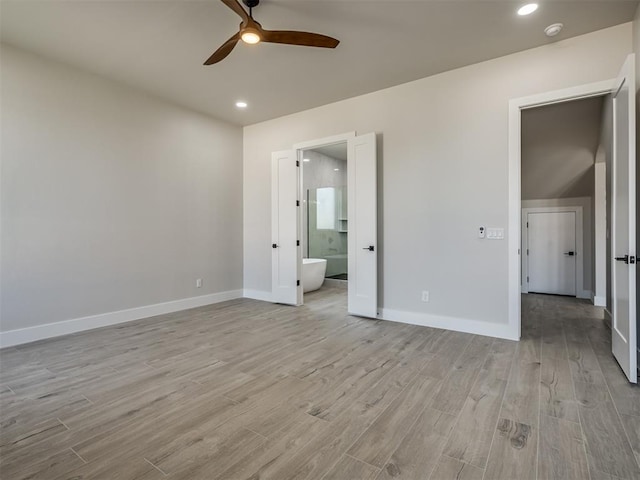 unfurnished bedroom featuring light hardwood / wood-style flooring, ensuite bath, and ceiling fan