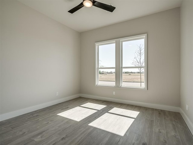 unfurnished room featuring hardwood / wood-style floors and ceiling fan