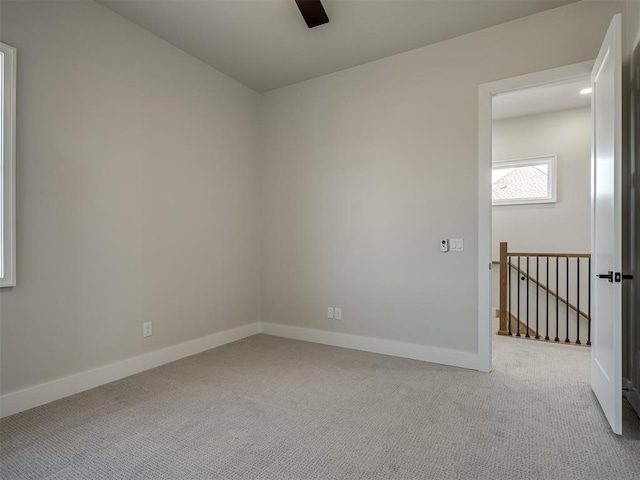 spare room featuring light carpet