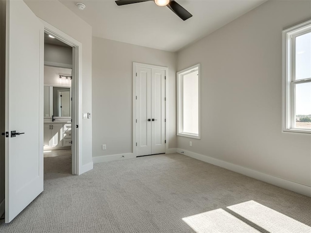 unfurnished bedroom with light carpet and ceiling fan