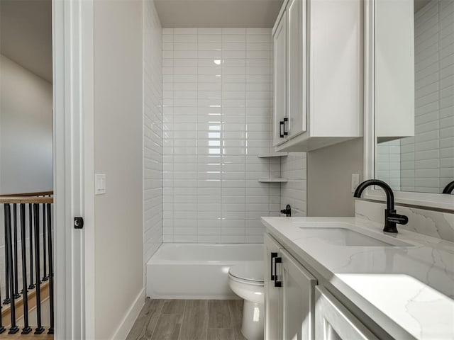 full bathroom featuring toilet, vanity, bathtub / shower combination, and hardwood / wood-style flooring