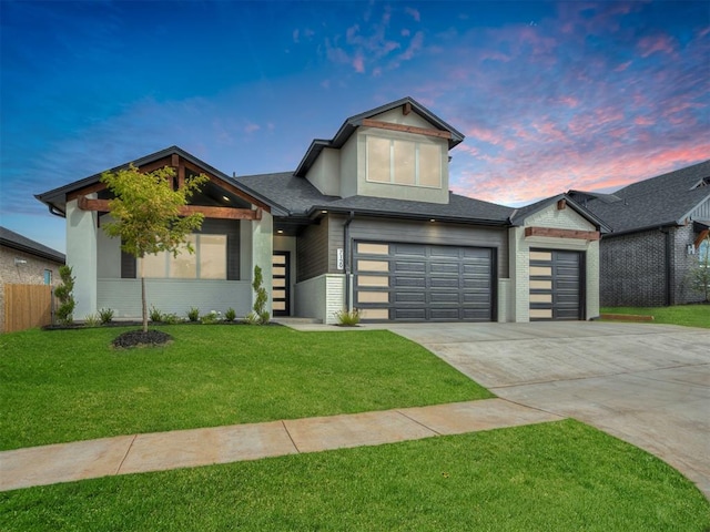 view of front facade with a garage and a lawn