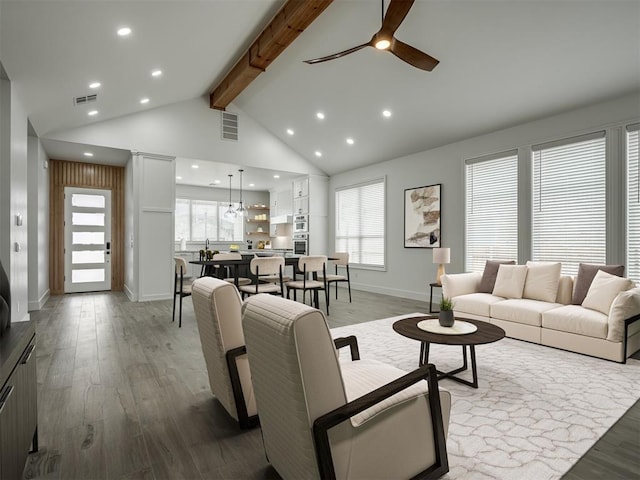 living room featuring beam ceiling, ceiling fan, high vaulted ceiling, and light hardwood / wood-style floors