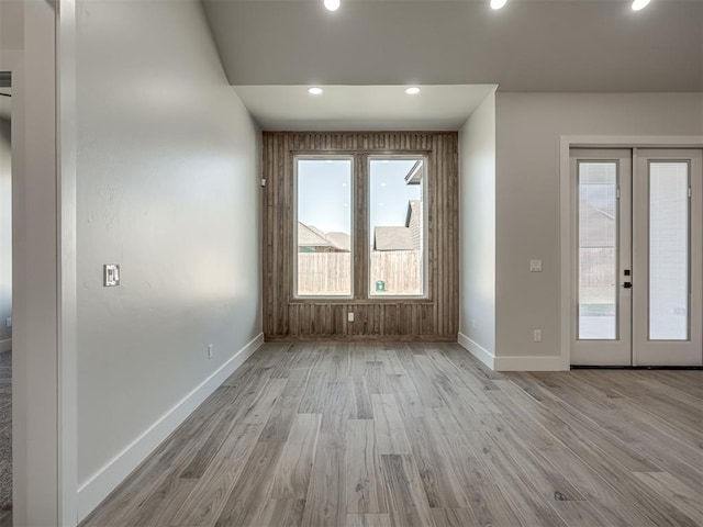 empty room with light wood-type flooring and french doors