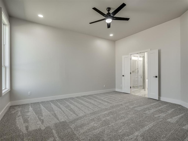 spare room featuring ceiling fan and carpet flooring