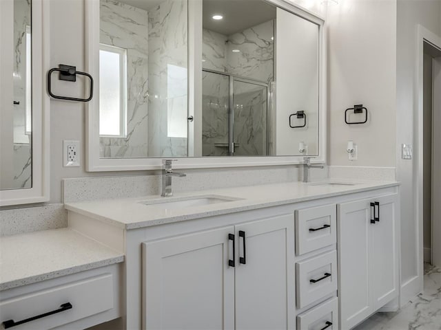 bathroom with vanity and a shower with shower door