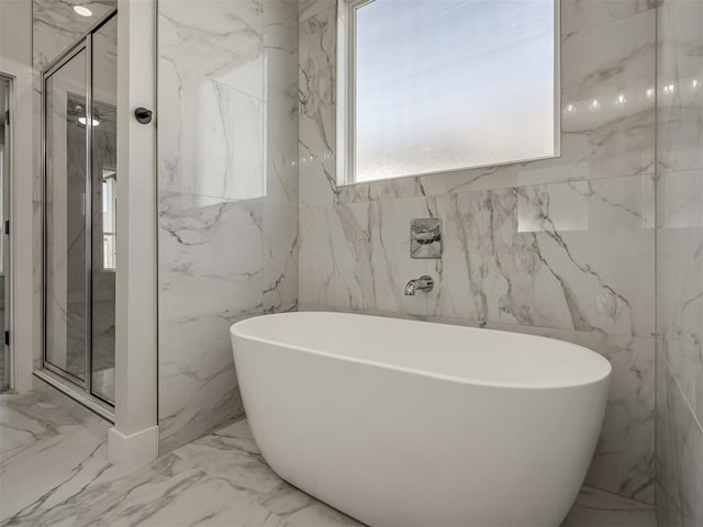 bathroom featuring shower with separate bathtub