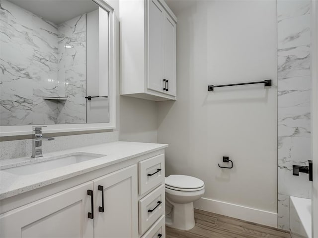 bathroom featuring vanity, toilet, and hardwood / wood-style floors