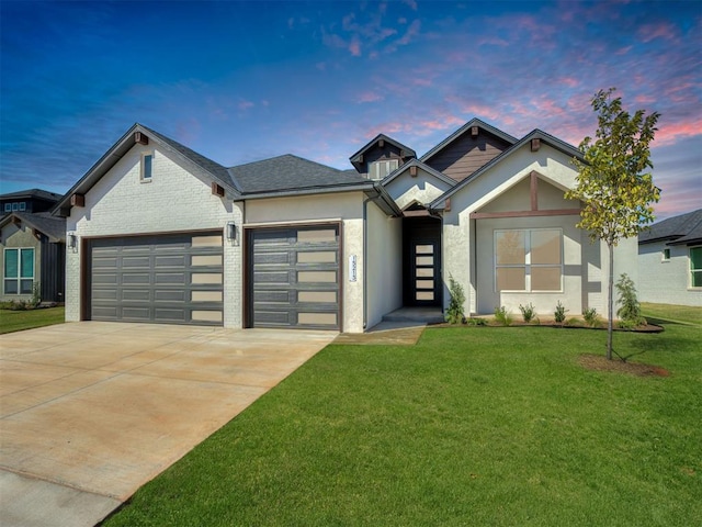 view of front of house featuring a garage and a lawn