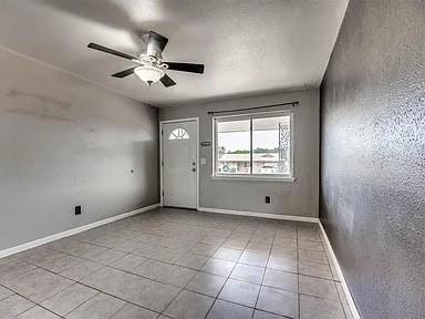 foyer entrance featuring ceiling fan and light tile patterned floors