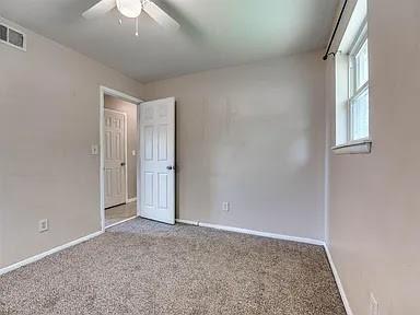 unfurnished room featuring carpet flooring and ceiling fan