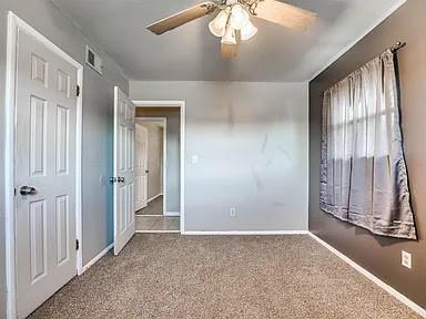 interior space with ceiling fan and carpet floors