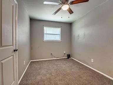 carpeted empty room featuring ceiling fan