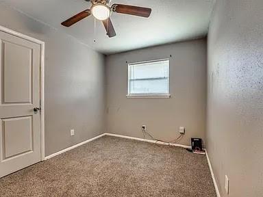 spare room with carpet floors and ceiling fan