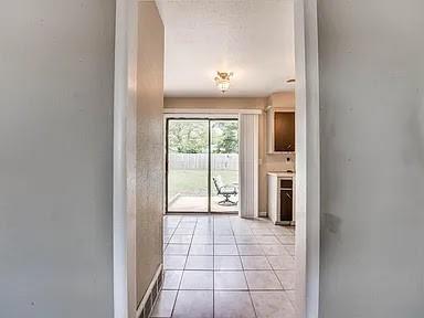 doorway featuring light tile patterned floors