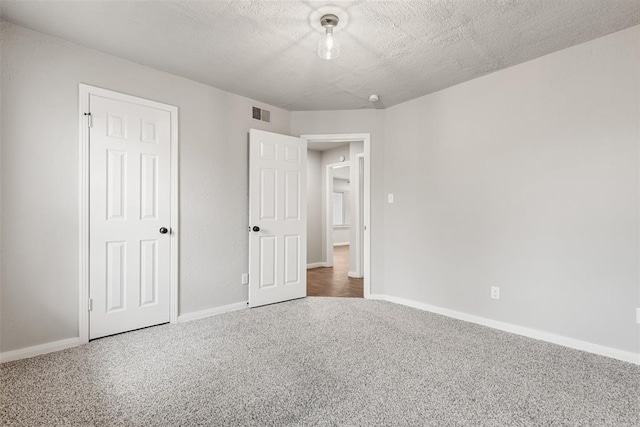 unfurnished bedroom with a textured ceiling and a closet