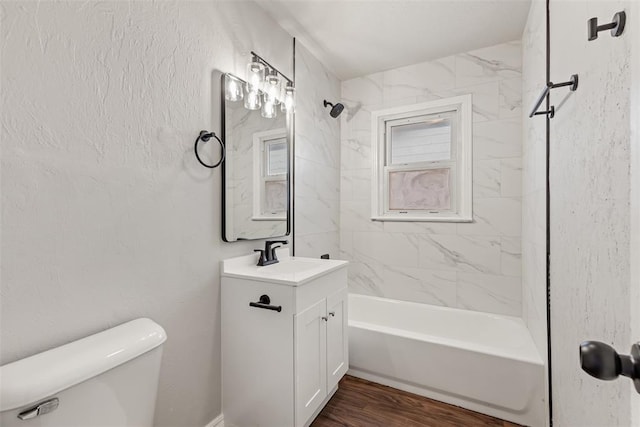 full bathroom with vanity, toilet, tiled shower / bath, and hardwood / wood-style flooring